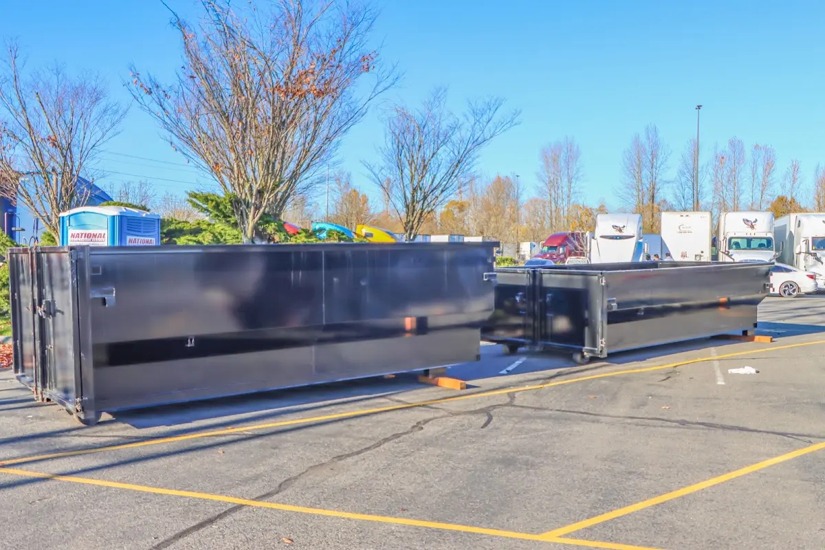 Professional dumpster rental service with roll-off container on residential driveway in Belleville